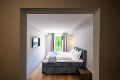 a bedroom with a bed and a window at Odilia - Historic City Apartments - center of Brixen in Bressanone