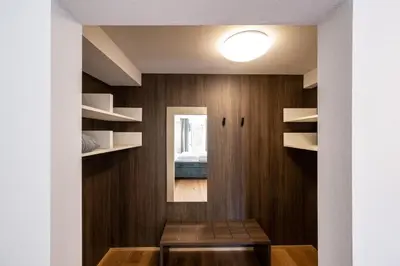 a room with a wooden wall with shelves and a table at Odilia - Historic City Apartments - center of Brixen in Bressanone