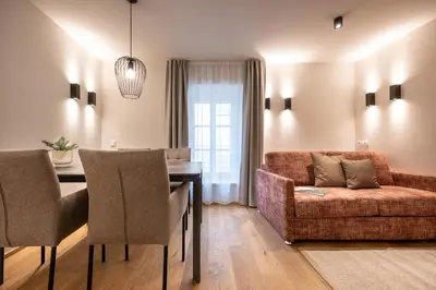 a living room with a couch and a table at Odilia - Historic City Apartments - center of Brixen in Bressanone