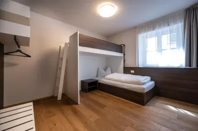 a bedroom with a bunk bed and a window at Odilia - Historic City Apartments - center of Brixen in Bressanone