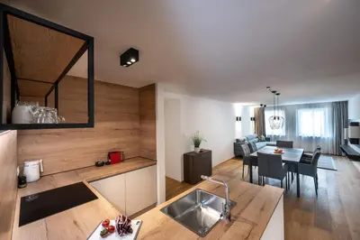 a kitchen and living room with a table and a dining room at Odilia - Historic City Apartments - center of Brixen in Bressanone