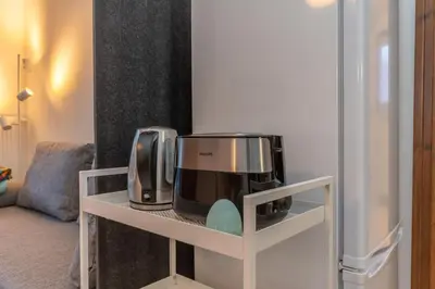 a coffee maker and microwave on a shelf in a room at Abetaia sul Lago in Alleghe