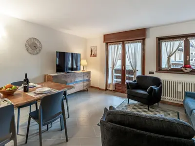 a living room with a couch and a table and chairs at Apartment Condominio Giulia by Interhome in Alba di Canazei