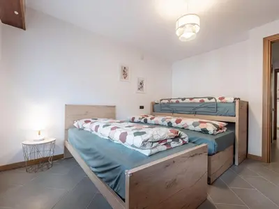 two twin beds in a room with a lamp at Apartment Condominio Giulia by Interhome in Alba di Canazei