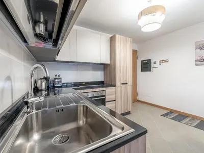 a kitchen with a stainless steel sink and a stove at Apartment Condominio Giulia by Interhome in Alba di Canazei