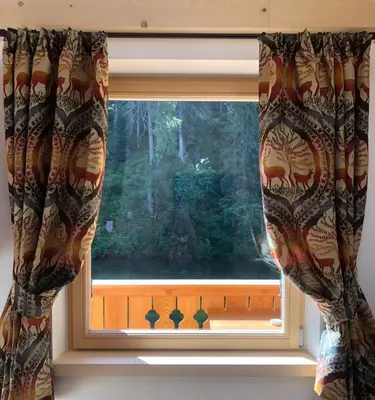 a window with curtains in a room at Rifugio Lago D'Ajal in Col