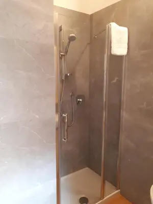 a shower with a glass door in a bathroom at Rifugio Lago D'Ajal in Col