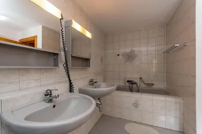 a bathroom with a sink and a tub and a sink at Casa Narciso in Rocca Pietore