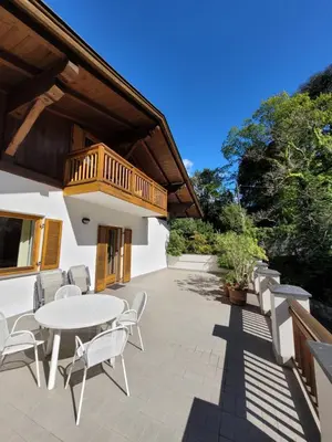 a patio with a table and chairs and a balcony at Appartements Lena in Merano