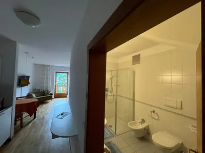 a bathroom with a shower and a toilet and a sink at Appartements Lena in Merano