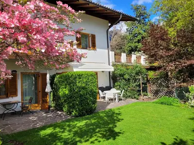 a house with a garden with pink flowers at Appartements Lena in Merano