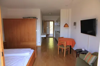 a small room with a bed and a table at Appartements Lena in Merano
