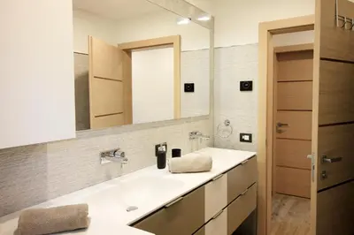 a bathroom with a sink and a mirror at CASA YARA - 3 camere, 2 bagni, parcheggio Dolomiti Affitti in Cavalese