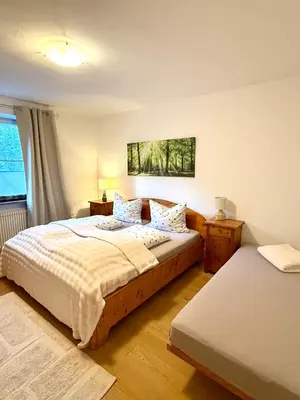 a bedroom with a bed and a couch and a window at Apartment Sonne auf Bio-Hof in Merano
