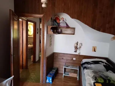a small bedroom with a bed and a mirror at Appartamento a San Vito di Cadore in San Vito di Cadore