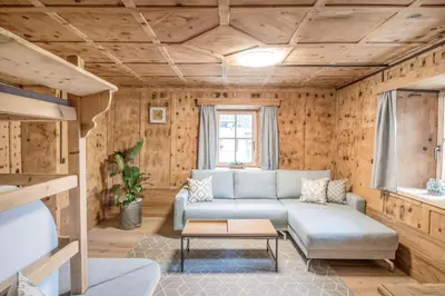 a room with a bunk bed and a couch at Pfitscherhof in Campo di Trens