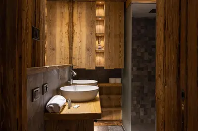 a bathroom with a white sink and a tub at Casa Ca dei Pini in Cortina dʼAmpezzo