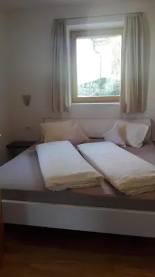 a bed with two pillows on it with a window at Panorama Residence Schlossblick - Apartments Erdgeschoss in Rodengo