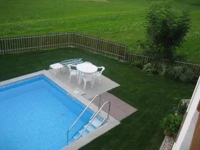 a backyard with a pool and a table and chairs at Panorama Residence Schlossblick - Apartments Erdgeschoss in Rodengo