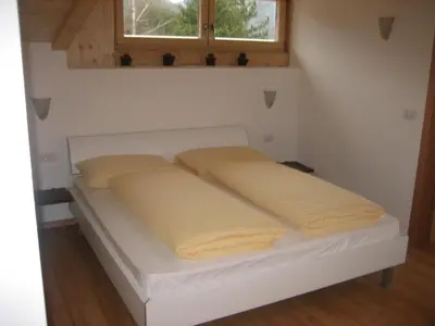 a bed in a room with yellow pillows on it at Panorama Residence Schlossblick - Apartments Erdgeschoss in Rodengo