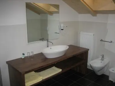 a bathroom with a sink and a toilet at Panorama Residence Schlossblick - Apartments Erdgeschoss in Rodengo