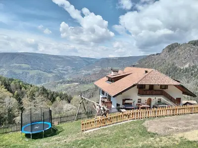 a house on a hill with a playground at Waldnerhof in Soprabolzano