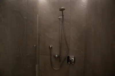 a shower in a bathroom with a glass door at Alpenglow Apartments in Collalbo